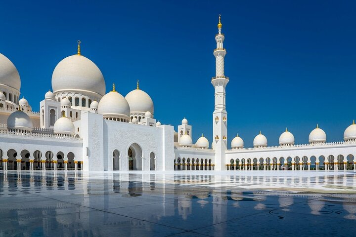 Experience the stunning blend of art and architecture at the Sheikh Zayed Grand Mosque where intricate design meets serene reflection showcasing Abu Dhabi's rich cultural heritage.
